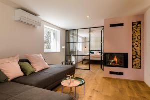 a living room with a couch and a fireplace at La Villa Ljubljana in Ljubljana