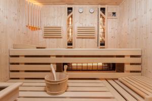 a sauna with a fireplace and clocks on the wall at Nawigator SPA in Rewal