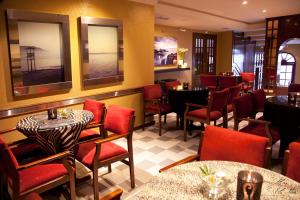 a restaurant with red chairs and tables in a room at Hotel Eli-Mar in A Guarda