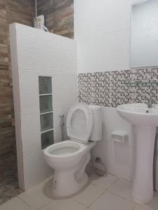 a bathroom with a toilet and a sink at Room62 in Wat Pa