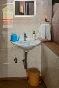 a bathroom with a sink and a mirror at Tent-O-Treat Premium Rooms near Dapoli in Dapoli