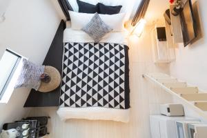 a room with two beds and pillows on a wall at Cozy Vibes Apt Hotel in Tokyo