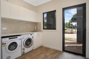 a laundry room with a washer and dryer at Telluride in Harrietville