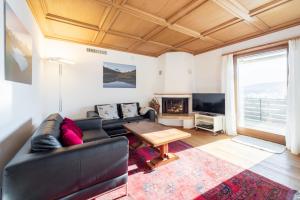 a living room with a couch and a table at Casa Murissen in Flims