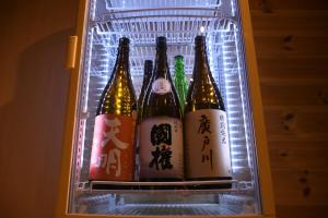 a refrigerator with six bottles of beer in it at Tsubaki - the best guesthouse in Inawashiro - in Inawashiro
