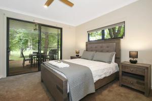 a bedroom with a large bed and a table with chairs at Telluride in Harrietville