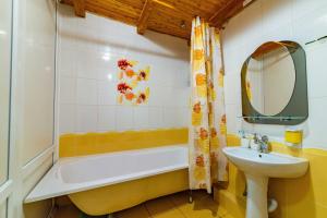 a bathroom with a tub and a sink and a mirror at хостел Галіція in Kolomiya +46 photos