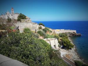 a building on a hill next to the ocean at U STUDIU 7 rue Notre Dame in Bastia
