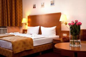 Postel nebo postele na pokoji v ubytování Hotel Aster an der Messe + 27 fotografií