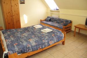 A bed or beds in a room at Afrodité Apartmanok