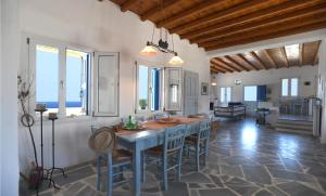 a kitchen with a table and chairs in a room at Villa Areti in Tinos