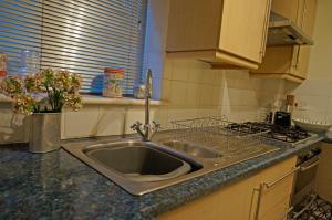 a kitchen with a sink and a stove at Fab Brunswick by the sea in Brighton & Hove