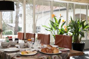 a table with plates of food on top at Boutique B&B de PASTORY in Zuiddorpe