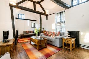 a living room with a couch and a tv at Burnside Hotel in Stratford-upon-Avon