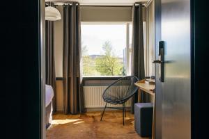 a small room with a chair and a window at ION Adventure Hotel, Nesjavellir, a Member of Design Hotels in Nesjavellir