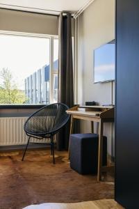 a room with a desk and a chair and a window at ION Adventure Hotel, Nesjavellir, a Member of Design Hotels in Nesjavellir