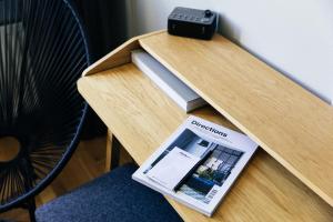 a table with a book and a clock on it at ION Adventure Hotel, Nesjavellir, a Member of Design Hotels in Nesjavellir