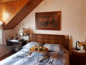 a bedroom with a bed with a tray of fruit on it at Holiday home Gariful in Milna