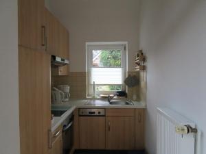 a small kitchen with a sink and a window at Ferienwohnung Sannhoff in Schneverdingen