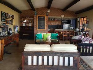 a living room with a couch and a table at The little Club Getaway at The Hay Barn in Lidgetton