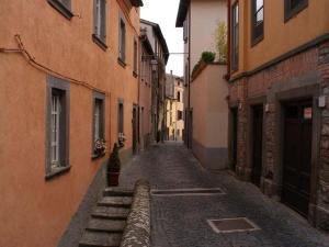an empty alley with buildings in a city at Historic house in Montefiascone