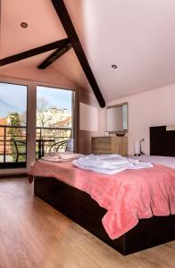 a large bedroom with a large bed and large windows at New Star Residence in Burgas City
