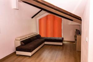 a living room with a couch and a red curtain at New Star Residence in Burgas City
