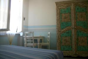 
A bed or beds in a room at Pensione Sorriso
