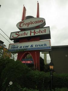 um sinal para um hotel ao lado de um edifício em Tropicana Suite Hotel em Vancouver