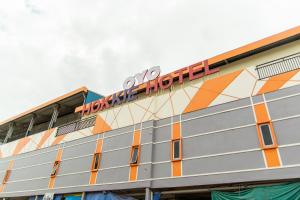 a building with a sign on top of it at Hokkie Hotel Punggur Batam in Nongsa