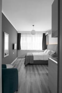 a bedroom with a bed and a large window at M&F Luxury Suites M Suite in Thessaloniki