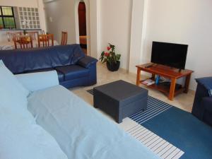 sala de estar con sofá azul y mesa en Ocean Dream Apartment en Funchal