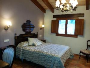 מיטה או מיטות בחדר ב-Country House El Permanyer