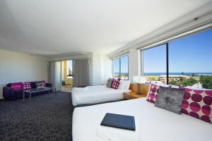 a hotel room with two beds and a large window at Best Western Plus Hotel Lord Forrest in Bunbury