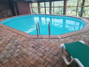 a large swimming pool with a table and a chair at Masia La Canal in Gombreny