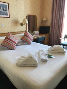 a hotel room with a bed with towels on it at Anchor Head Hotel in Weston-super-Mare