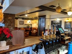 a bar with a bunch of bottles of wine at Sparkford Inn in Sparkford