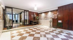 a lobby with a checkered floor and a table at Cà Mocenigo Terrace in Venice