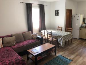 a living room with a couch and a table at Vila Idila in Crni Vrh