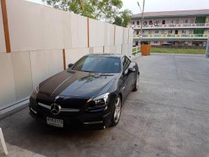 a black car parked in a parking lot at THE ROOM 24 RESORT in Pathum Thani