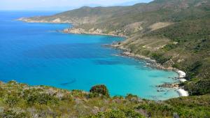 an aerial view of a bay with blue water at A ChiOsella in Corbara