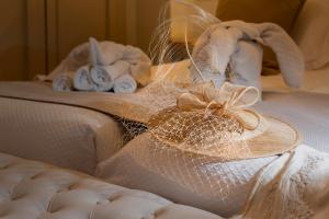 a hat on top of a bed with towels at Hostal Boutique Plaza Cantarero in Nerja