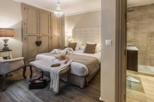 a bedroom with a large bed and a desk at Hostal Boutique Plaza Cantarero in Nerja