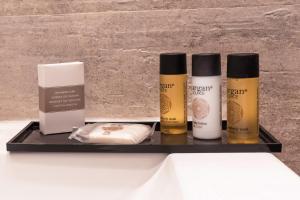 a black tray with three differentials of cosmetics on it at Hostal Boutique Plaza Cantarero in Nerja