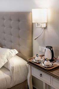 a hotel room with a bed and a telephone on a table at Hostal Boutique Plaza Cantarero in Nerja