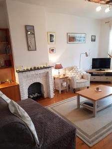 a living room with a couch and a fireplace at Quai Peree Apartement in Saint-Valéry-sur-Somme