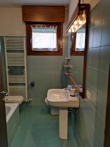 a bathroom with two sinks and a mirror and a tub at Horus apartment in Padova