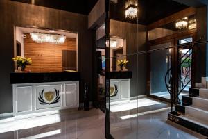 a lobby with a staircase and a glass elevator at Willa Pieńkowskich in Gdynia +38 photos
