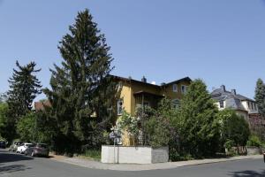 a house on the side of a street with trees at Apartment der Villa Elsa in Dresden