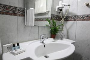 a bathroom with a white sink and a mirror at Arma Hotel in Manisa